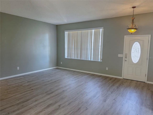 foyer with wood-type flooring and a textured ceiling