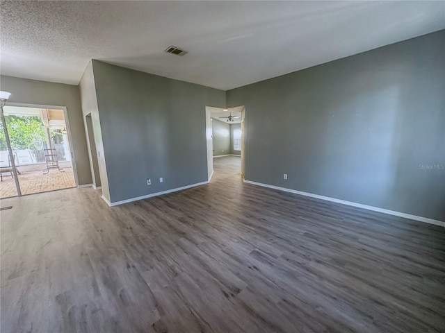 unfurnished room featuring a textured ceiling and hardwood / wood-style flooring