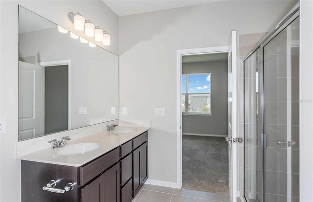 8322 SW 52nd Lane Rd, Ocala, FL 34481 - bathroom with baseboards, a sink, tile patterned flooring, and a tile shower