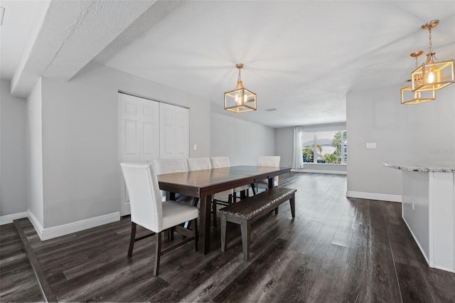 dining room with dark hardwood / wood-style flooring and a textured ceiling