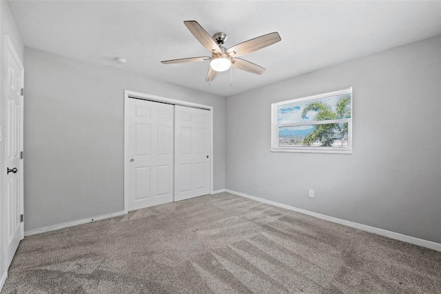 unfurnished bedroom with ceiling fan, carpet floors, and a closet