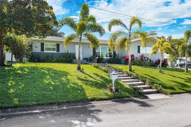 single story home featuring a front lawn