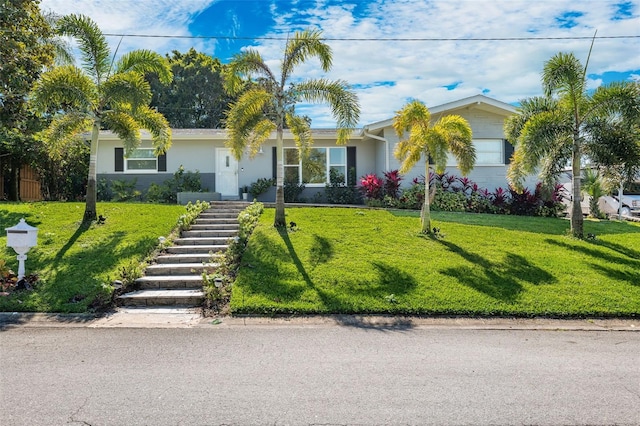 single story home featuring a front lawn