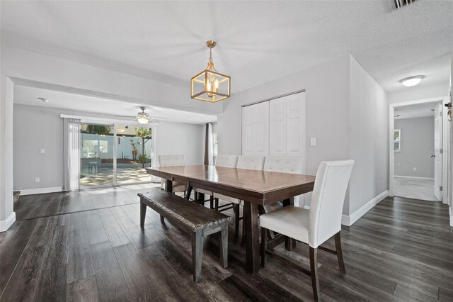 dining room with a textured ceiling, ceiling fan with notable chandelier, and dark hardwood / wood-style floors