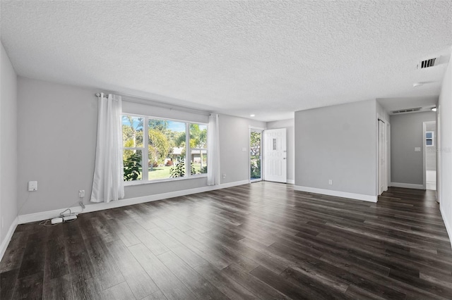 unfurnished room featuring dark hardwood / wood-style floors and a textured ceiling