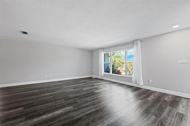 unfurnished room with dark hardwood / wood-style flooring and a textured ceiling