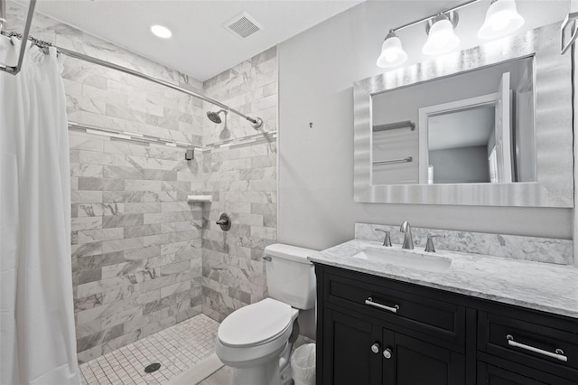 bathroom with vanity, a shower with shower curtain, and toilet