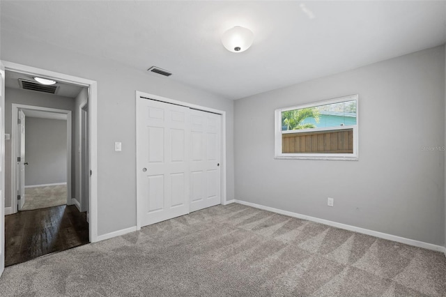 unfurnished bedroom featuring carpet and a closet