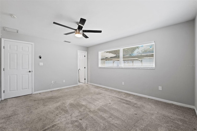 carpeted spare room with ceiling fan