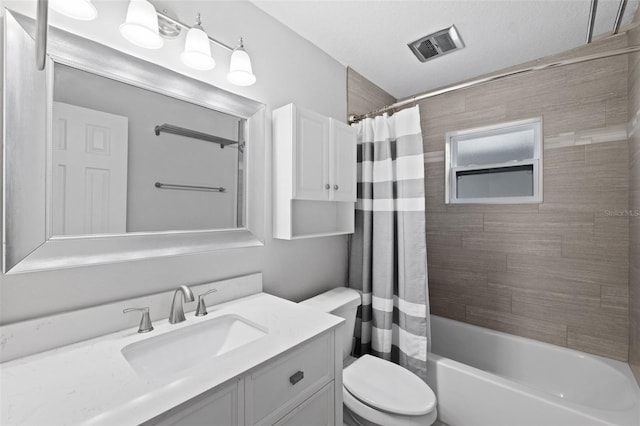 full bathroom with a textured ceiling, vanity, shower / bath combo, and toilet