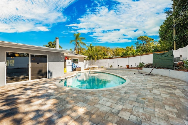 view of swimming pool with a patio