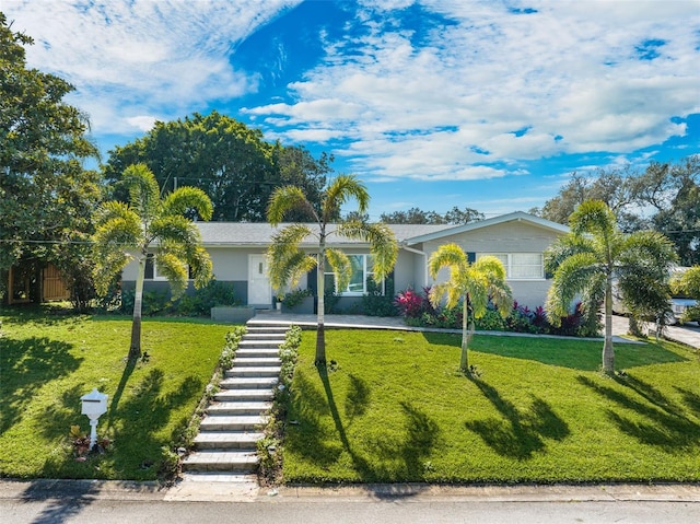 ranch-style house featuring a front lawn