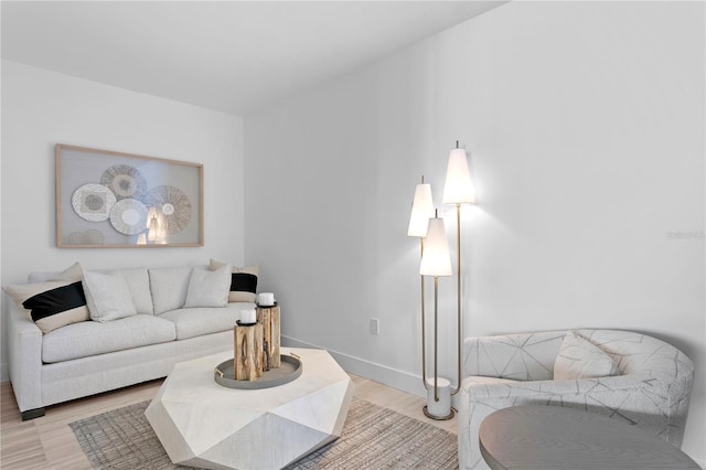 living room with baseboards and wood finished floors