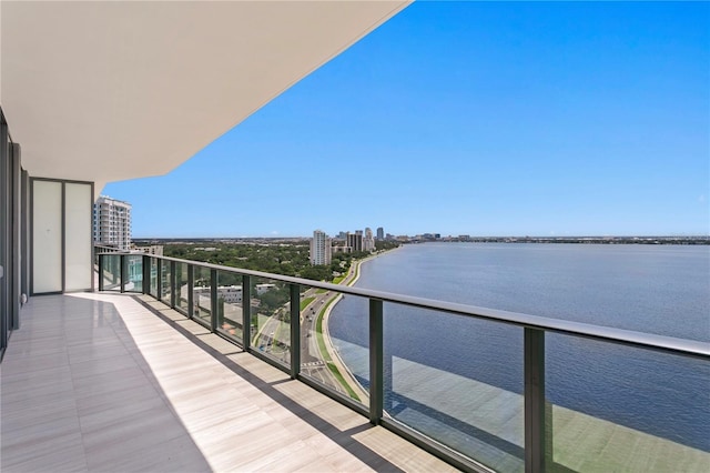 balcony featuring a view of city and a water view