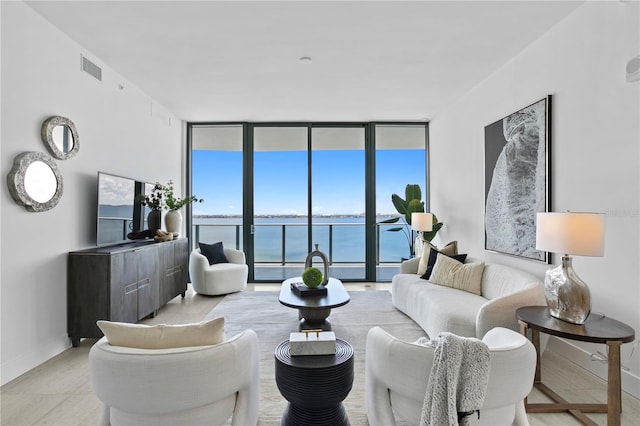 living room featuring a wall of windows and plenty of natural light