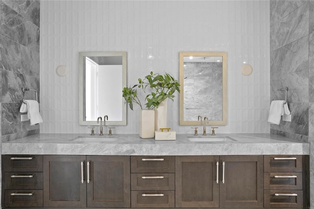 bathroom with vanity and tile walls