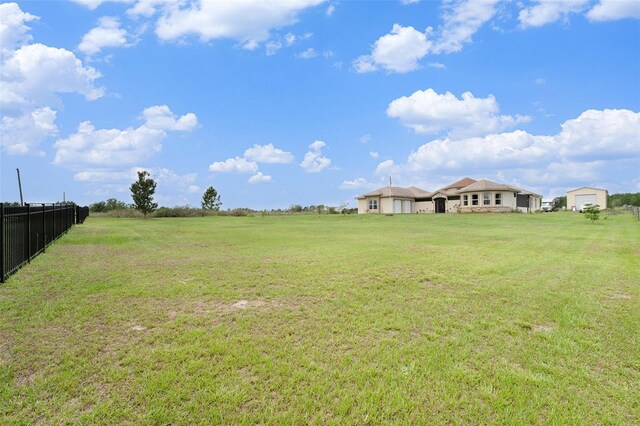 view of yard featuring a garage and a rural view