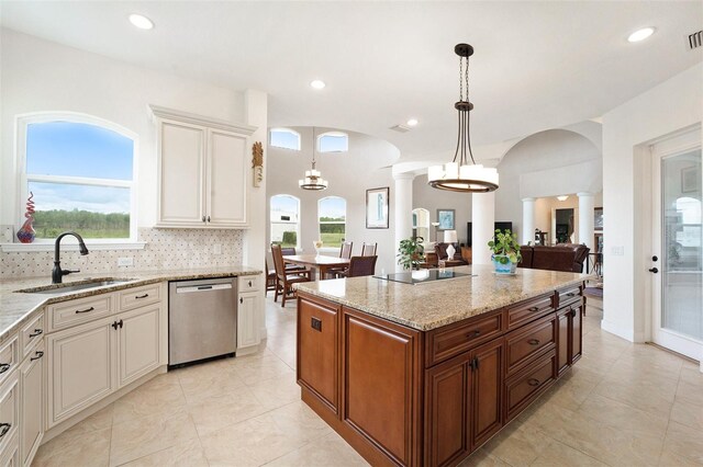 kitchen with decorative columns, light tile patterned floors, dishwasher, hanging light fixtures, and decorative backsplash