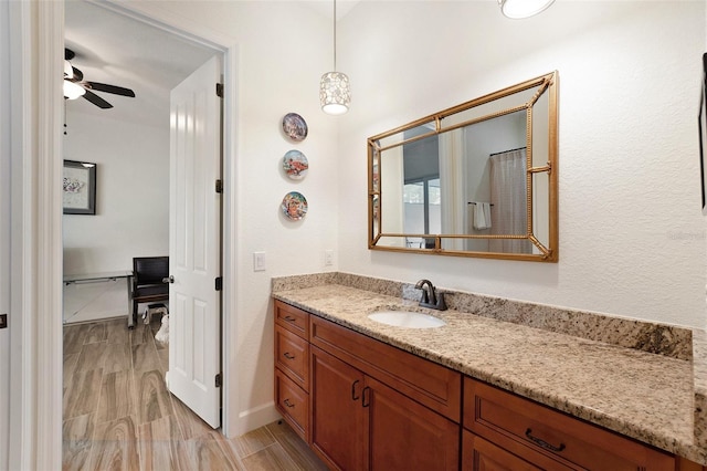 bathroom featuring hardwood / wood-style flooring, vanity, and ceiling fan