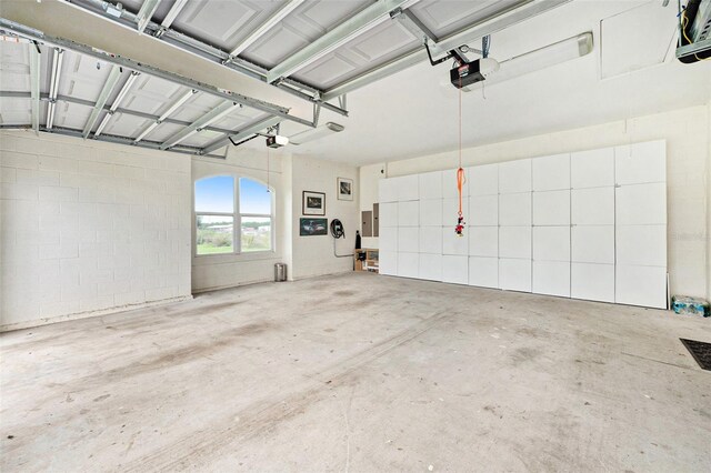 garage featuring a garage door opener and electric panel