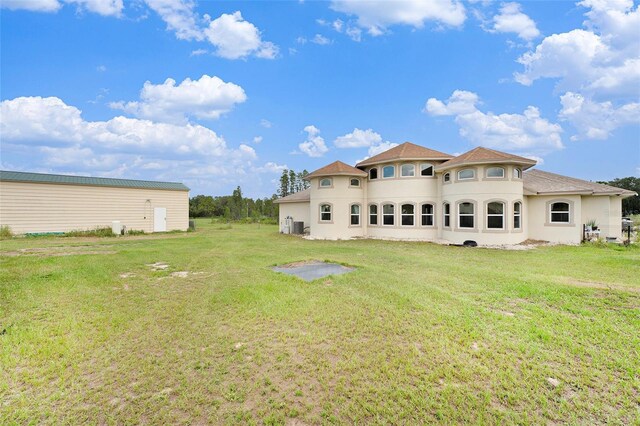 back of house with a lawn