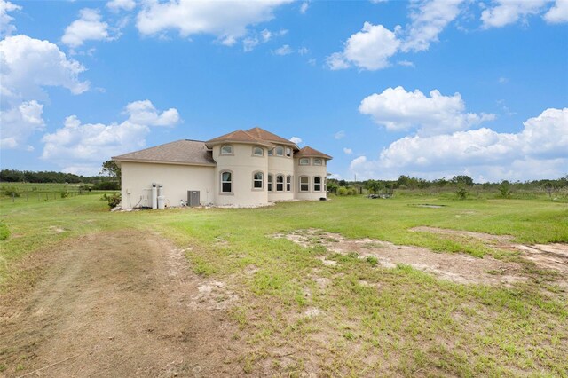 rear view of property with a yard