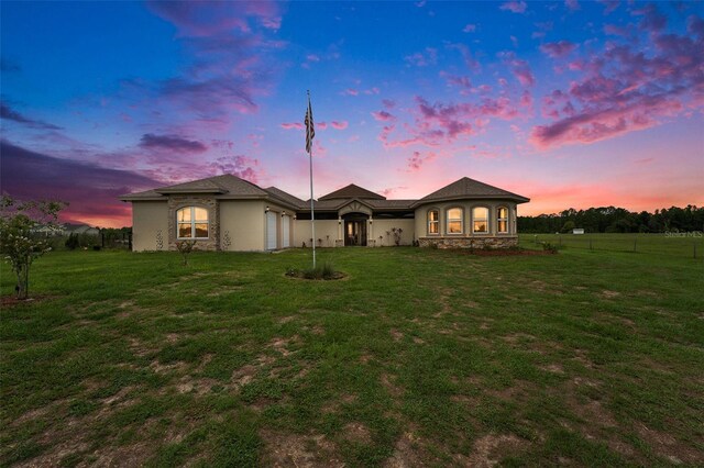 ranch-style house with a lawn