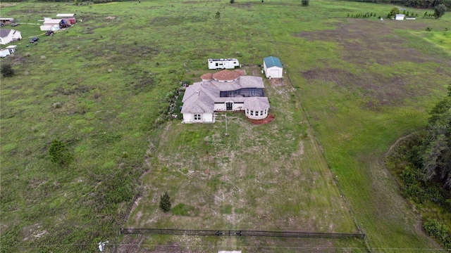 birds eye view of property with a rural view