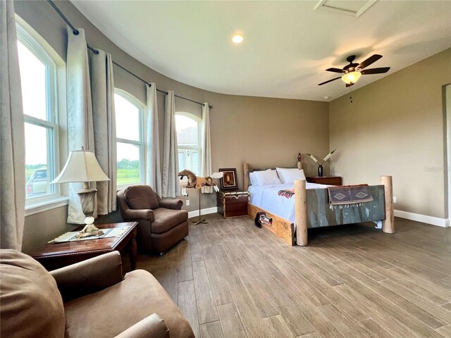 bedroom with ceiling fan and hardwood / wood-style floors