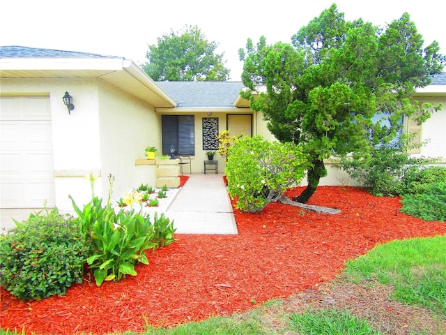 view of exterior entry with a garage