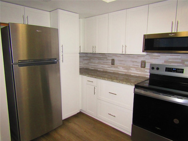 kitchen featuring white cabinetry, light stone countertops, tasteful backsplash, dark hardwood / wood-style flooring, and appliances with stainless steel finishes