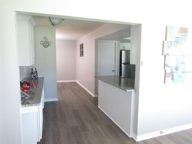 corridor with dark hardwood / wood-style flooring