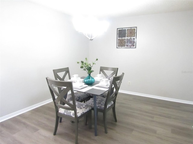 dining area with dark hardwood / wood-style flooring