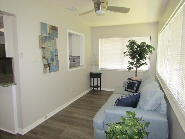 living area featuring dark hardwood / wood-style floors and ceiling fan