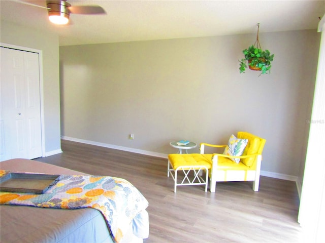 bedroom featuring hardwood / wood-style flooring, a closet, and ceiling fan