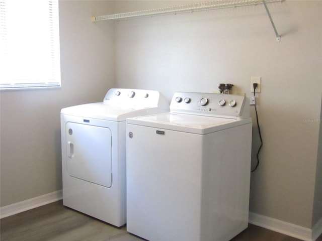 clothes washing area featuring hardwood / wood-style floors and washing machine and clothes dryer