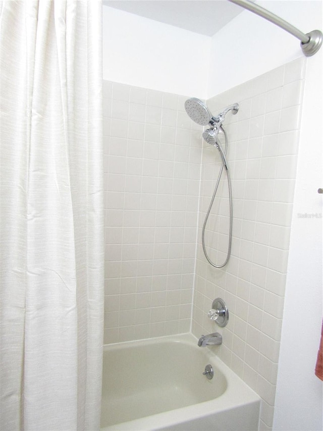 bathroom featuring shower / bathtub combination with curtain