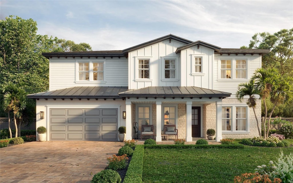 view of front facade featuring a garage, a front lawn, and a porch