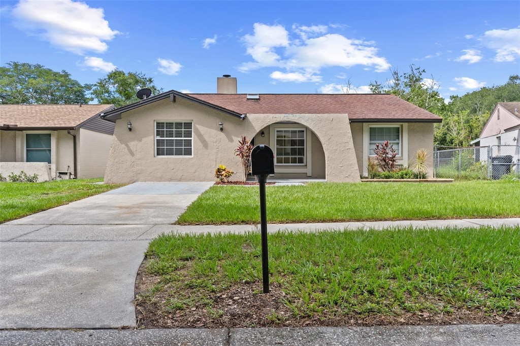 ranch-style home with a front yard