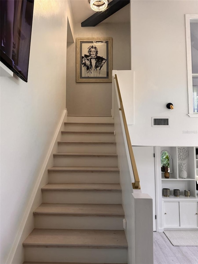 stairway featuring wood-type flooring