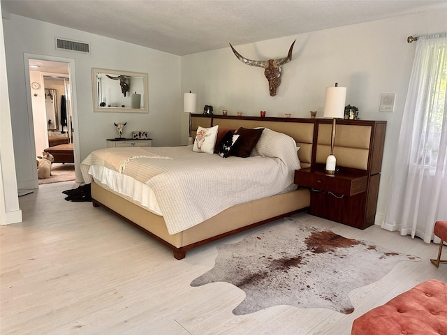 bedroom with light hardwood / wood-style flooring