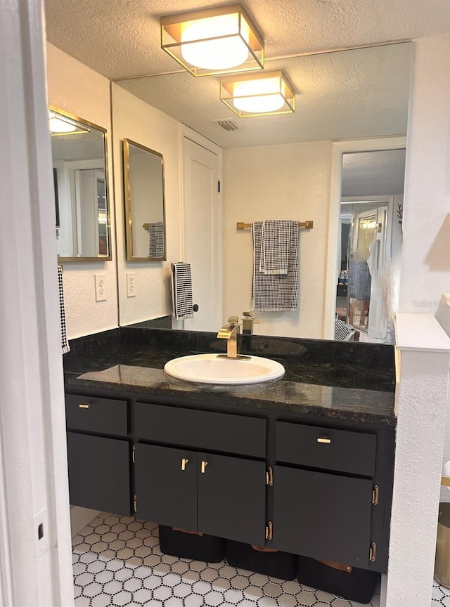 bathroom with vanity and a textured ceiling