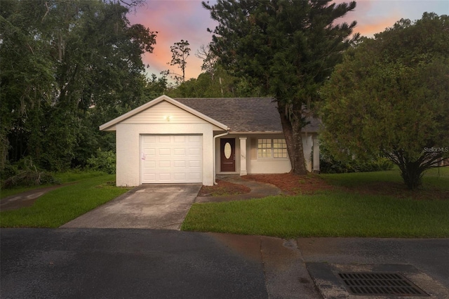 view of front of property featuring a garage and a yard