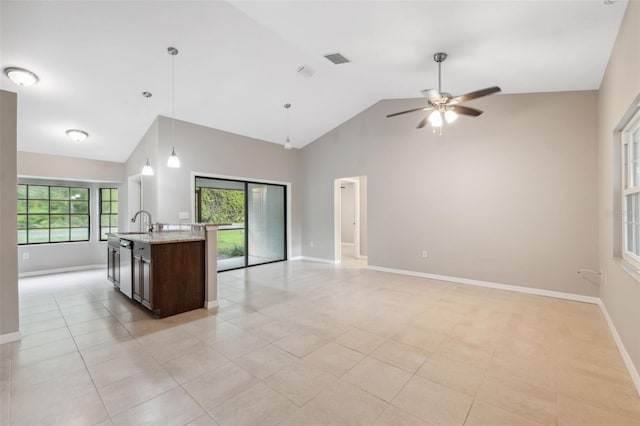 kitchen featuring pendant lighting, light tile patterned floors, and lofted ceiling