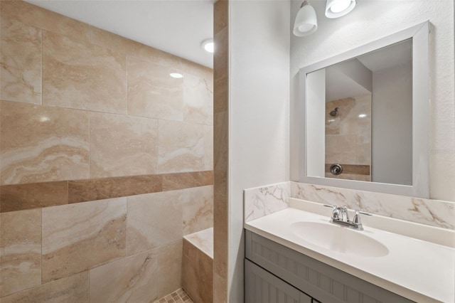 bathroom featuring vanity and tiled shower