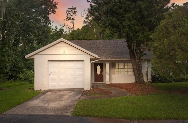 single story home with a yard and a garage