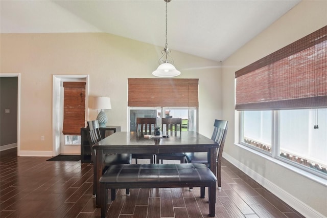 dining room with dark hardwood / wood-style floors, vaulted ceiling, and a wealth of natural light