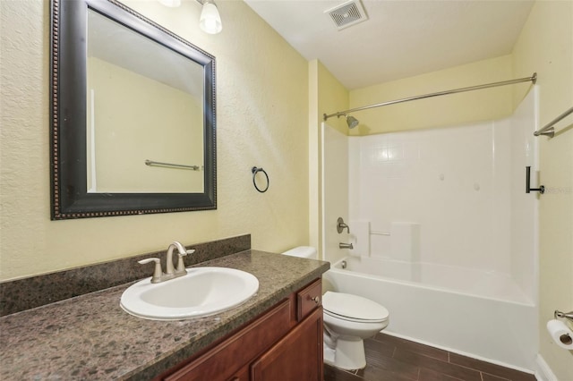 full bathroom featuring vanity, toilet, and  shower combination