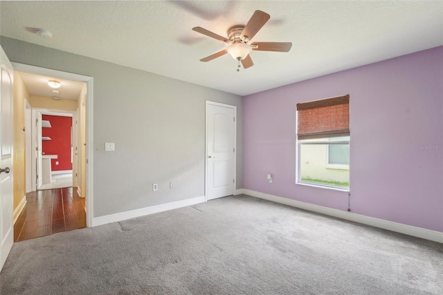 unfurnished room featuring carpet and ceiling fan