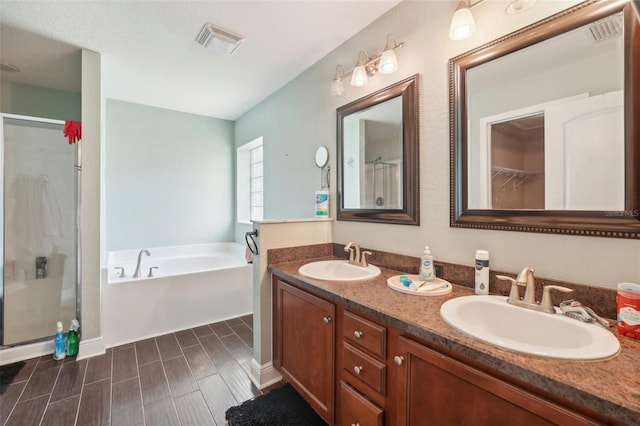 bathroom with vanity and independent shower and bath